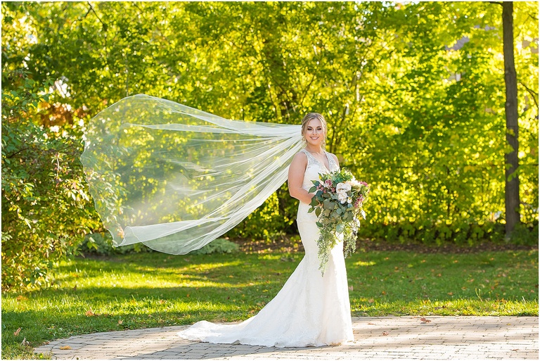 Bride with veil blowing in the wind.